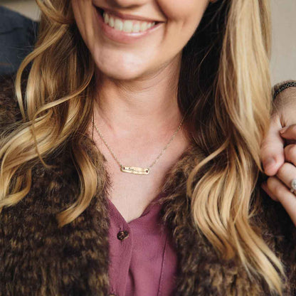 woman wearing 10k yellow gold written with love necklace