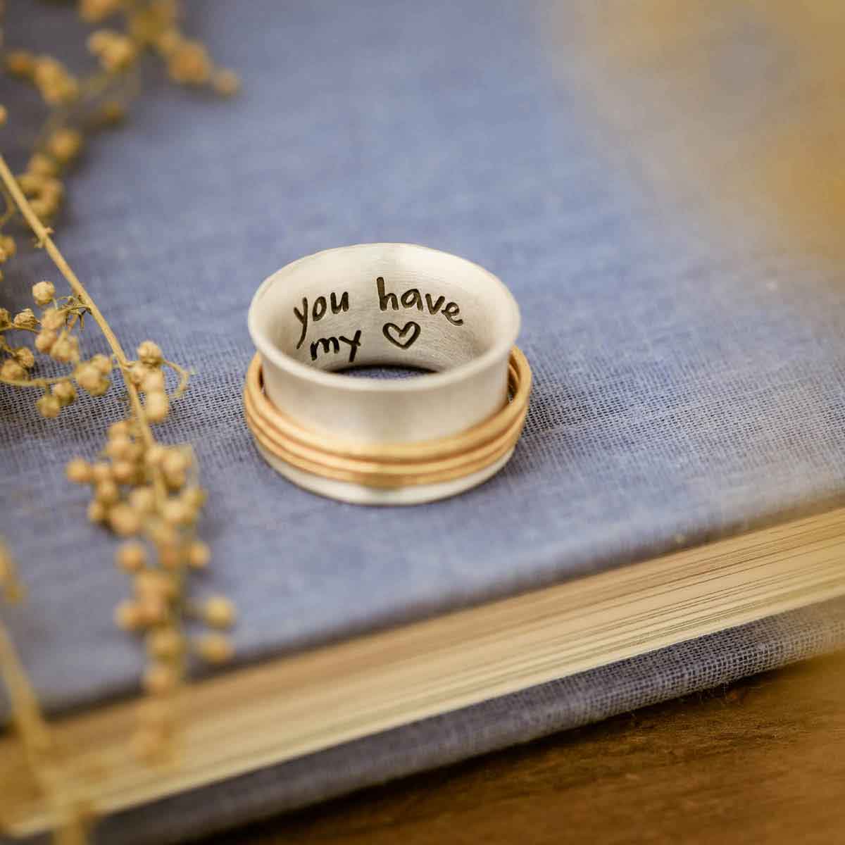 you have my heart spinner ring {sterling silver & 10k gold} on a blue book