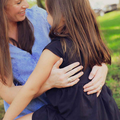 daughter holding mom's hand wearing the you have my heart spinner ring {sterling silver & 10k gold}