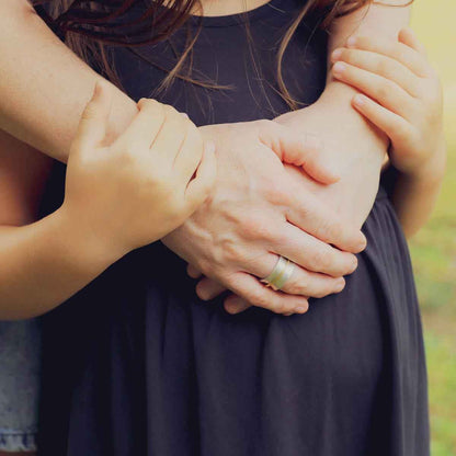 mom wearing the you have my heart spinner ring {sterling silver & 10k gold} holding daughter