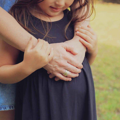 mom wearing the you have my heart spinner ring {sterling silver & 10k gold} holding daughter