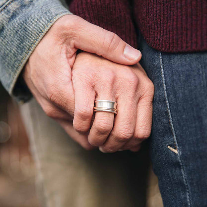 Woman wearing her You Have my Heart Spinner ring with a sterling silver band and gold-filled spinners and phrase engraved on the inside