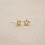 Your Spark Earrings, handcrafted in 14k yellow gold, set with a 1.5mm cubic zirconia, on beige background