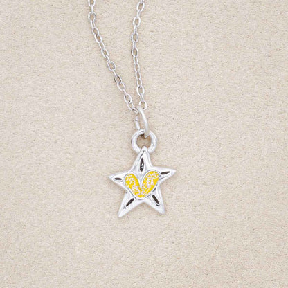 your spark kids necklace, filled with glitter yellow epoxy, on a beige background