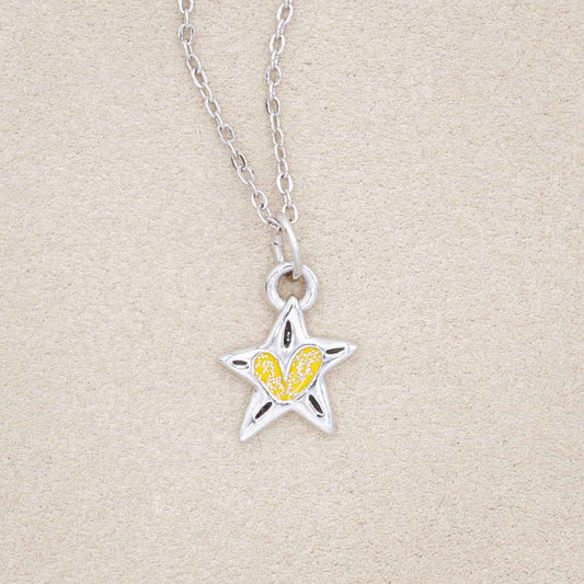 your spark kids necklace, filled with glitter yellow epoxy, on a beige background