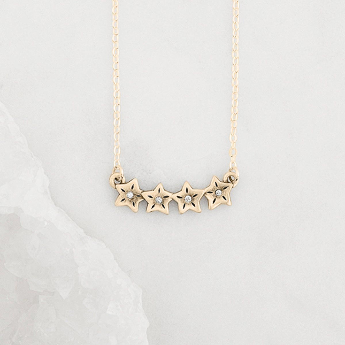 10k yellow gold your spark necklace with 1.5mm cubic zirconia in each star and strung on gold-filled chain chain