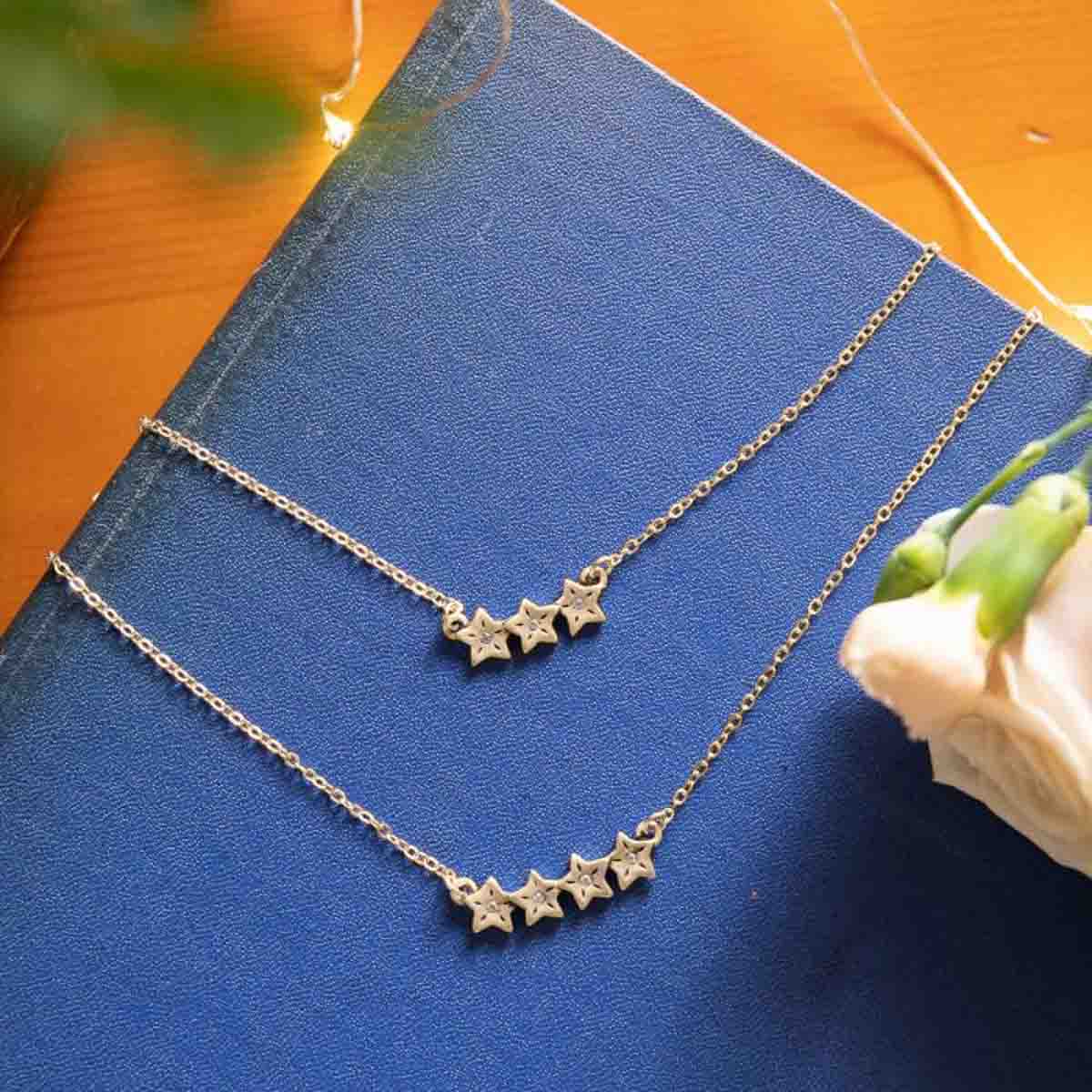 10k yellow gold your spark necklace with 1.5mm cubic zirconia in each star and strung on gold-filled chain chain