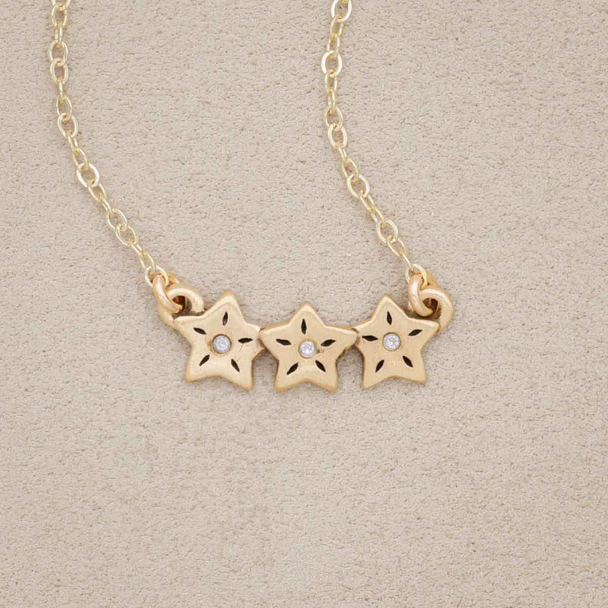 14k yellow gold your spark necklace with 1.5mm cubic zirconia in each star and strung on gold-filled chain chain