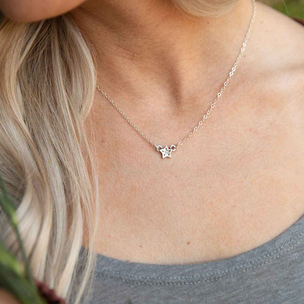 girl wearing sterling silver your spark necklace with 1.5mm cubic zirconia in each star and strung on silver link chain