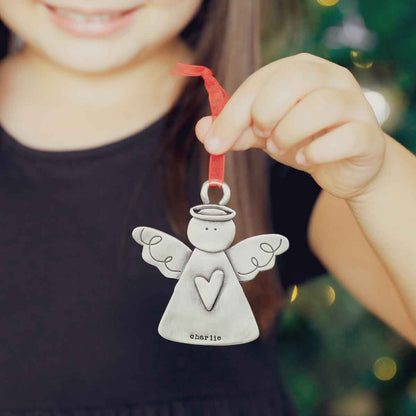 girl holding the you're my angel ornament 